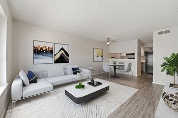 A modern living room with a white sofa and a coffee table.